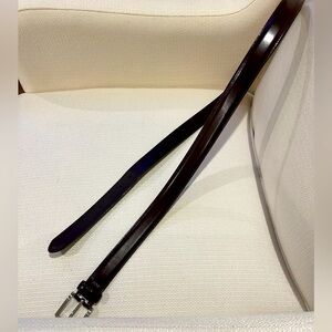 Brown leather belt with silver buckle.